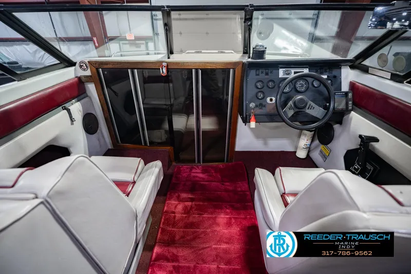 Slide: The Image of Interior of a 1986 Regal Sebring 195 boat with red and white seating. - 18