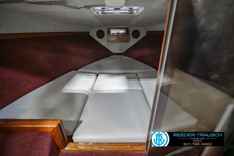 Slide: The Image of Interior cabin of a 1986 Regal Sebring 195 boat with cushioned seating. - 20