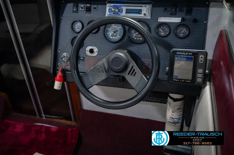 Slide: The Image of 1986 Regal Sebring 195 dashboard with steering wheel, gauges, and Eagle fish finder. - 28