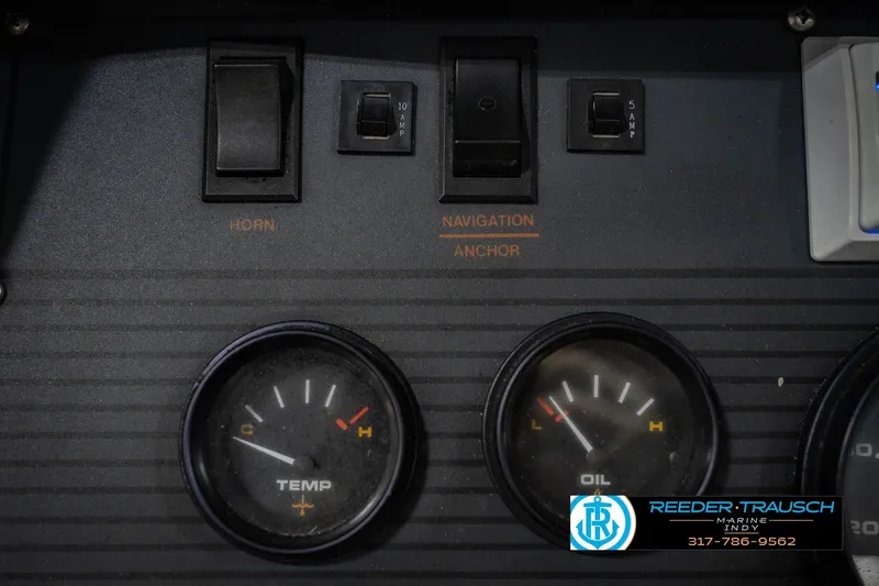 Slide: The Image of Dashboard of a 1986 Regal Sebring 195 boat with gauges and switches. - 33