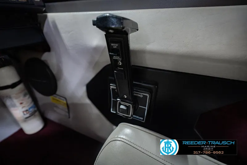 Slide: The Image of Interior control panel of a 1986 Regal Sebring 195 boat, featuring trim adjustment lever. - 38