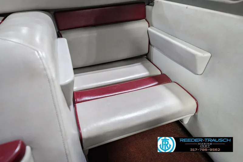 Slide: The Image of 1986 Regal Sebring 195 boat interior with white and red seating, Reeder-Trausch Marine logo. - 41
