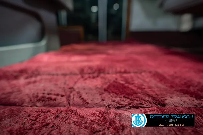 Slide: The Image of Red carpet interior of a 1986 Regal Sebring 195 boat, featuring Reeder-Trausch Marine logo. - 44