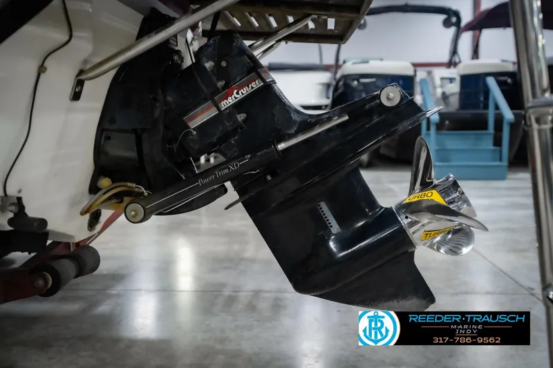 Slide: The Image of 1986 Regal Sebring 195 boat with MerCruiser outdrive and Turbo propeller in a showroom. - 46