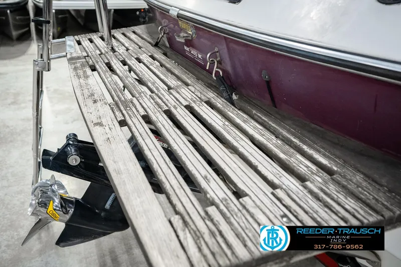 Slide: The Image of 1986 Regal Sebring 195 boat with wooden swim platform and visible propeller. - 54