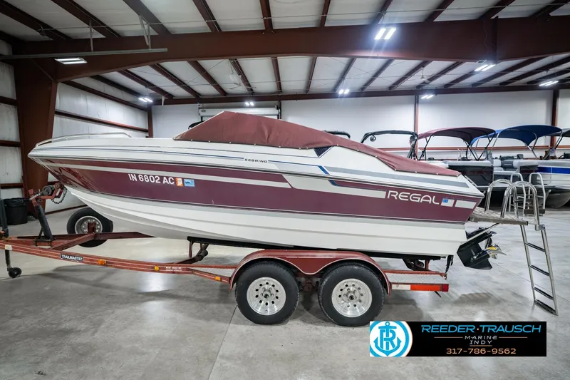 Slide: The Image of 1986 Regal Sebring 195 boat on trailer in indoor storage facility. - 55
