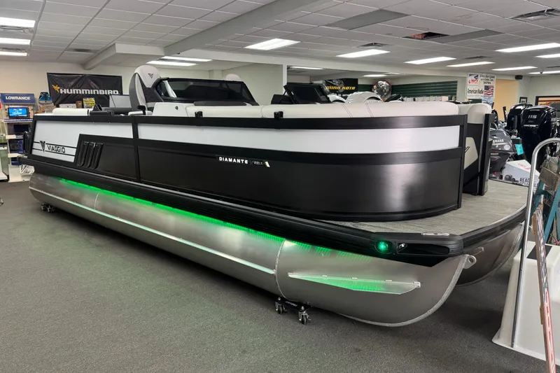 The Image of 2026 Viaggio Diamante 22UW pontoon boat displayed indoors with green underglow lighting. - 0