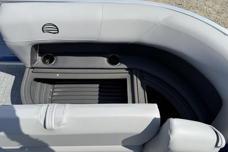 Slide: The Image of Sun Tracker Party Barge 16 DLX 2026, featuring gray seating and cup holders. - 11