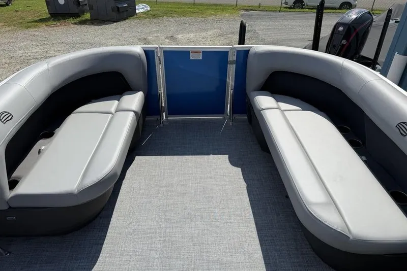 Slide: The Image of 2026 Sun Tracker Party Barge 16 DLX interior with gray seating and carpeted floor. - 5