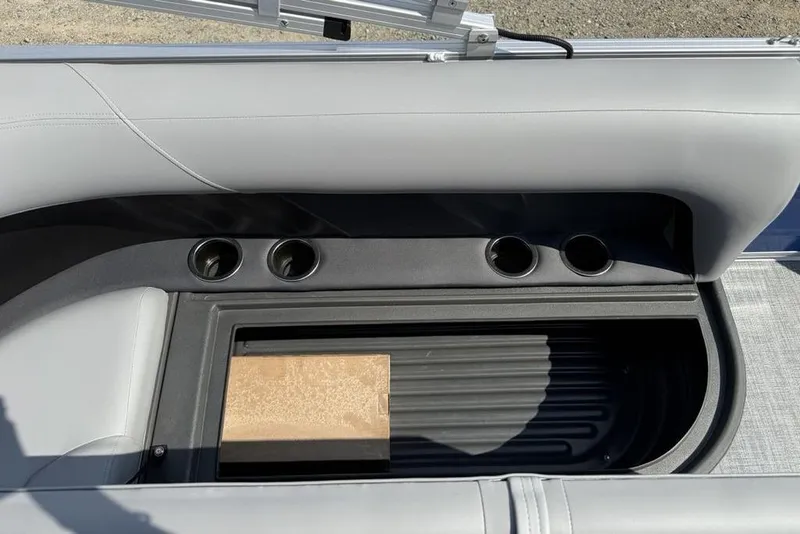 Slide: The Image of Interior of 2026 Sun Tracker Party Barge 16 DLX with cup holders and storage compartment. - 6