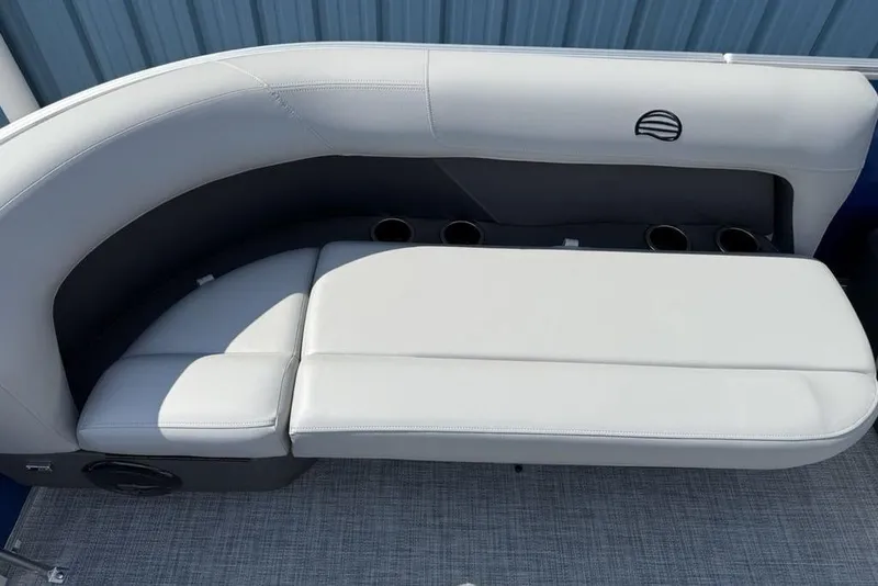 Slide: The Image of 2026 Sun Tracker Party Barge 16 DLX seating area with cup holders and cushioned seats. - 8