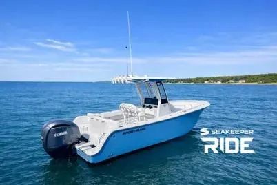 Slide: The Image of 2023 Sportsman Heritage 231 Center Console boat on open water, featuring Seakeeper Ride technology. - 10