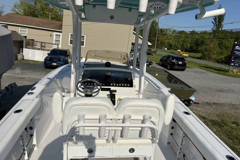 Slide: The Image of 2023 Sportsman Heritage 231 Center Console boat with white seating and modern dashboard. - 8