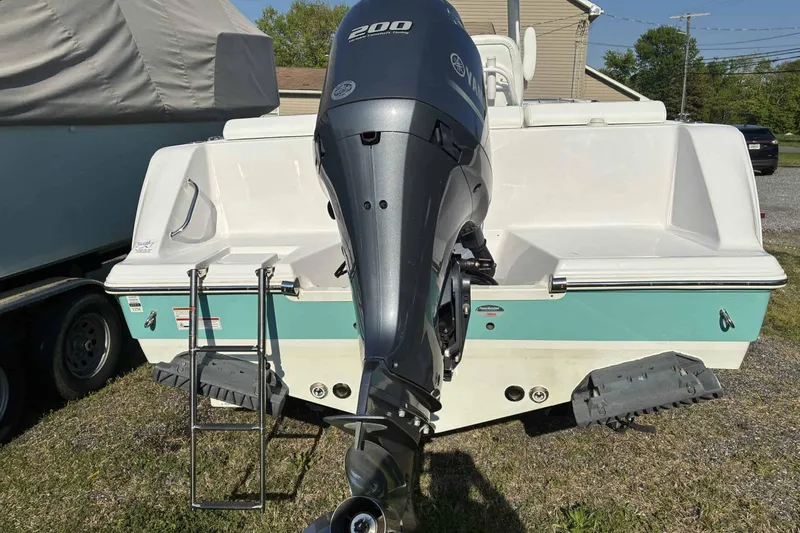 Slide: The Image of 2023 Sportsman Heritage 231 Center Console boat with Yamaha 200 engine, parked outdoors. - 9