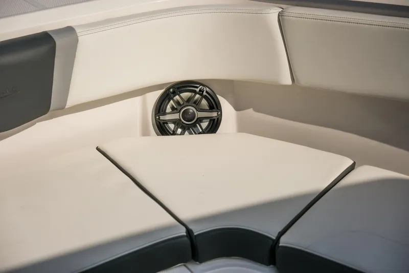 Slide: The Image of 2025 Robalo R300 Center Console boat interior with cushioned seating and speaker. - 10