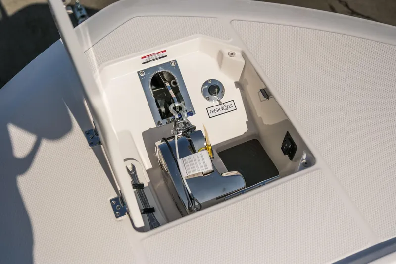 Slide: The Image of 2025 Robalo R300 Center Console anchor compartment with fresh water access. - 12