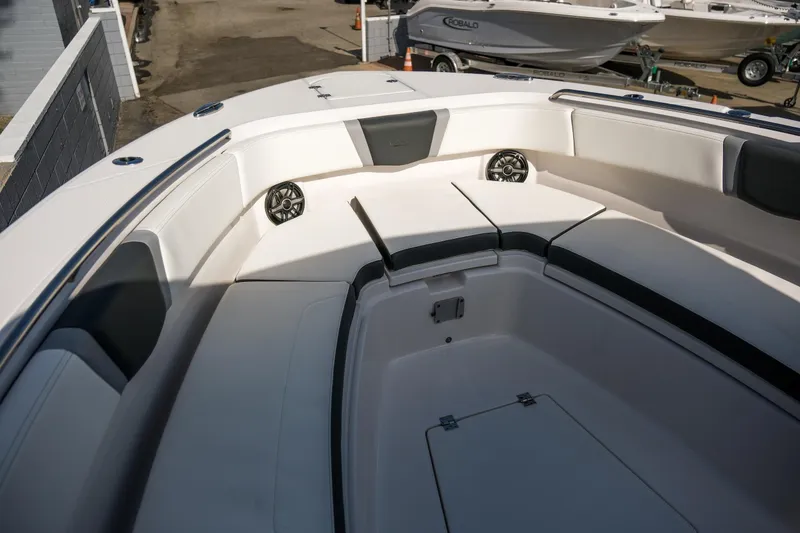 Slide: The Image of 2025 Robalo R300 Center Console boat interior with cushioned seating and speakers. - 28