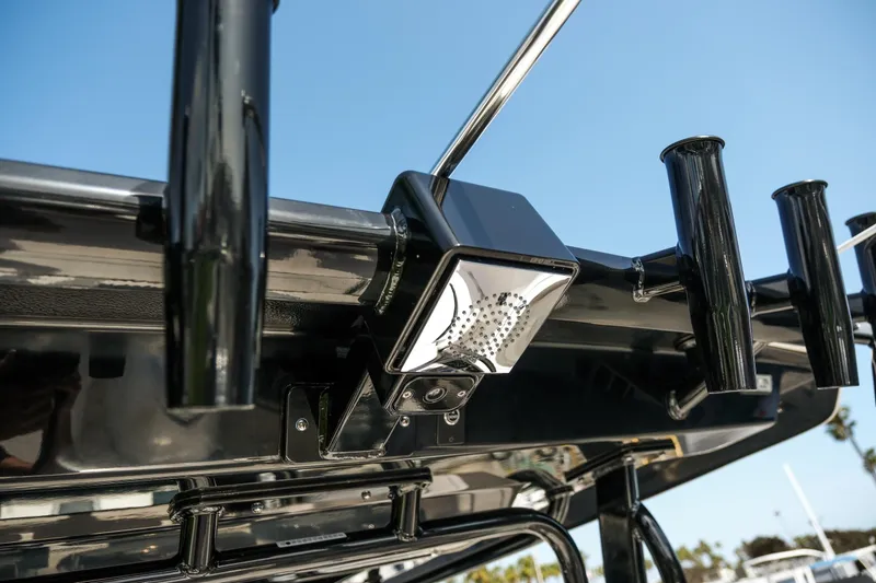 Slide: The Image of 2025 Robalo R300 Center Console boat with rod holders and LED light detail. - 38
