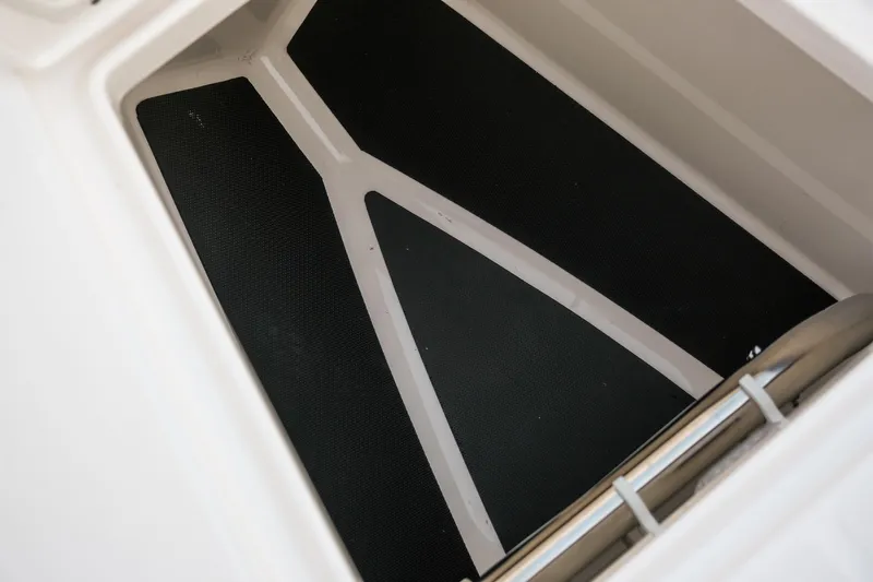 Slide: The Image of 2025 Robalo R300 Center Console storage compartment with non-slip flooring. - 7