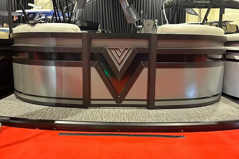 Slide: The Image of 2026 Viaggio Lago X22U pontoon boat with sleek metallic design on red carpet. - 22