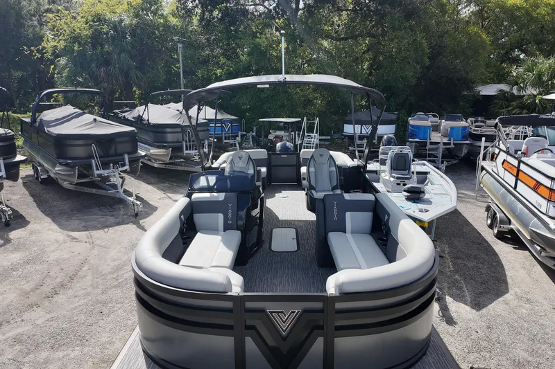 Slide: The Image of 2026 Viaggio Lago X22U pontoon boat in a showroom, surrounded by other boats. - 6