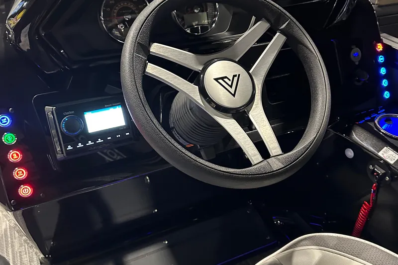 Slide: The Image of Steering wheel and dashboard of 2026 Viaggio Lago X22U boat with illuminated controls. - 19