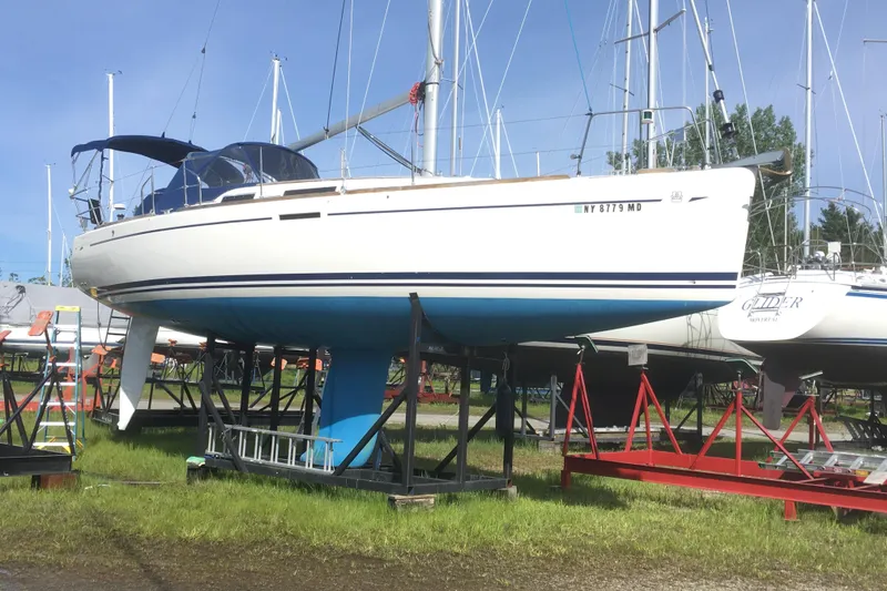 Slide: The Image of 2004 Dufour 34 Performance sailboat on stands in a marina. - 11