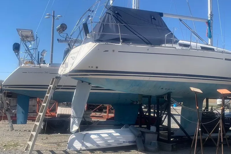 Slide: The Image of Sailboats in dry dock, featuring a 2004 Dufour 34 Performance model. - 13