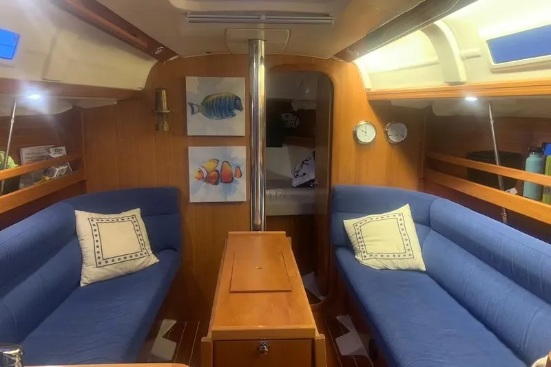 Slide: The Image of Interior of 2004 Dufour 34 Performance yacht with blue seating and nautical decor. - 15