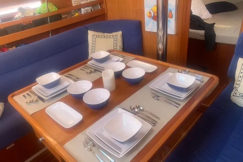 Slide: The Image of Elegant dining setup in a 2004 Dufour 34 Performance yacht interior. - 17