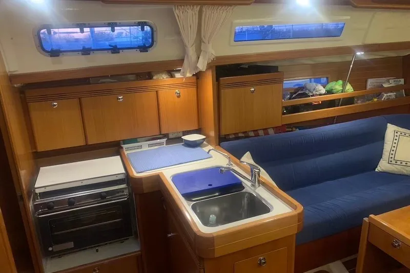 Slide: The Image of Interior of 2004 Dufour 34 Performance yacht with kitchen and seating area. - 20
