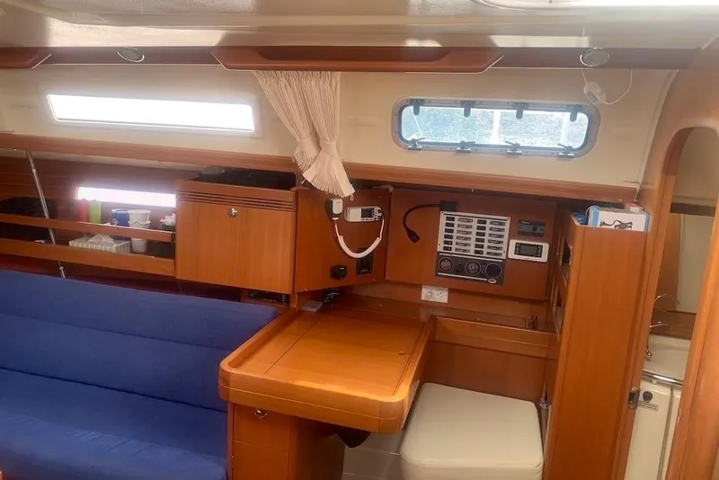 Slide: The Image of Interior of 2004 Dufour 34 Performance yacht with wooden cabinetry and blue seating. - 21