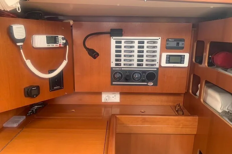 Slide: The Image of Control panel of a 2004 Dufour 34 Performance yacht, featuring navigation and communication equipment. - 22