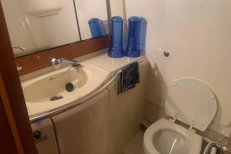 Slide: The Image of Bathroom interior of 2004 Dufour 34 Performance yacht, featuring sink and toilet. - 26