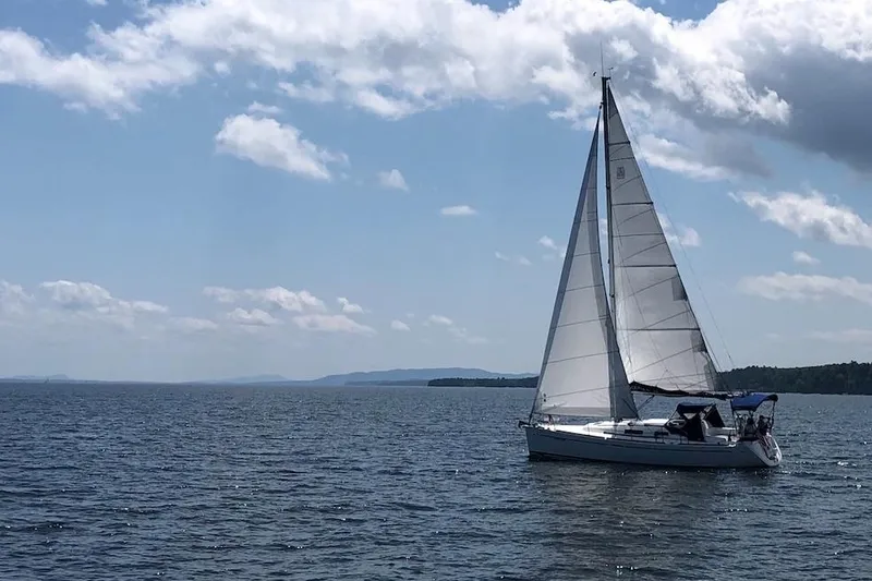 Slide: The Image of Sailing yacht Dufour 34 Performance 2004 on open water under a clear sky. - 3