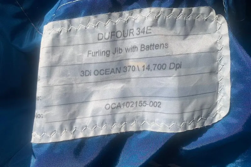 Slide: The Image of Label on blue fabric for Dufour 34 Performance, 2004, furling jib with battens. - 30