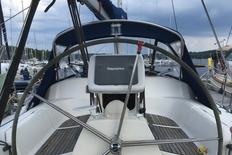 Slide: The Image of Cockpit of 2004 Dufour 34 Performance sailboat with steering wheel and navigation equipment. - 4