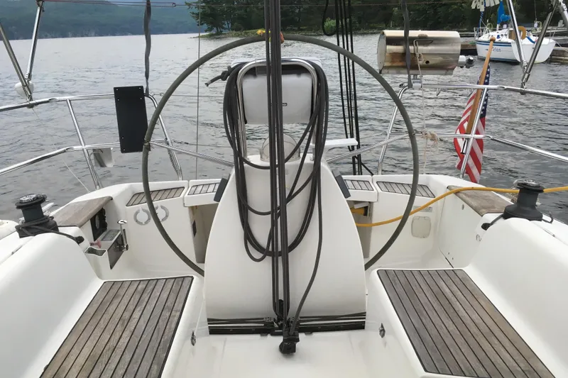 Slide: The Image of Cockpit of 2004 Dufour 34 Performance sailboat with wooden seating and steering wheel. - 5
