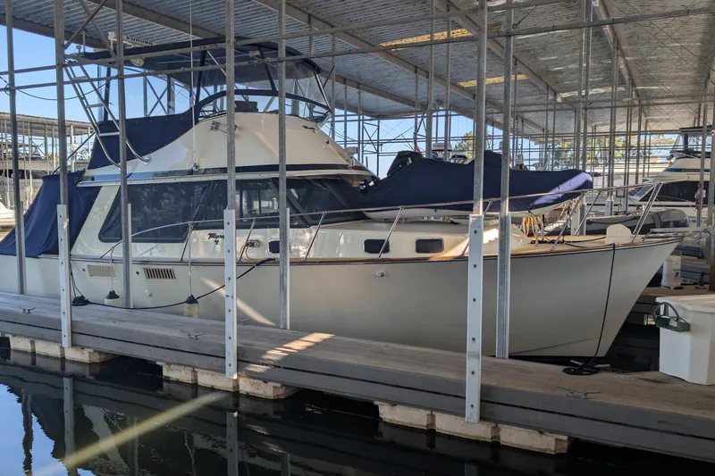 The Image of 1975 Tollycraft 37 Sedan yacht docked in a covered marina. - 0