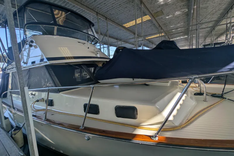 Slide: The Image of 1975 Tollycraft 37 Sedan yacht docked under a covered marina. - 10