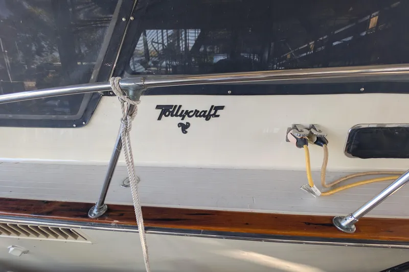 Slide: The Image of 1975 Tollycraft 37 Sedan boat with railing and logo detail. - 12