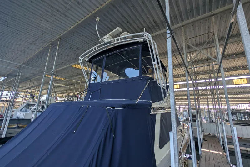 Slide: The Image of 1975 Tollycraft 37 Sedan boat docked under a metal canopy. - 15