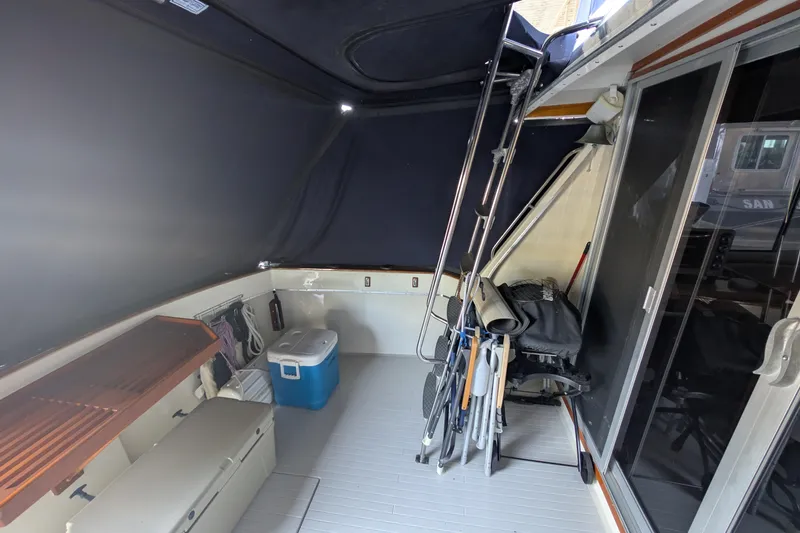 Slide: The Image of 1975 Tollycraft 37 Sedan interior with storage, cooler, and ladder. - 17