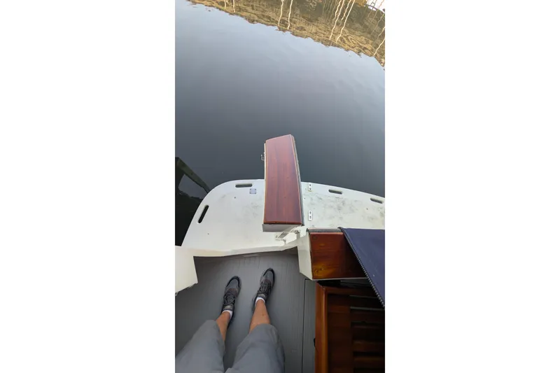 Slide: The Image of 1975 Tollycraft 37 Sedan boat deck with person standing, overlooking calm water. - 19