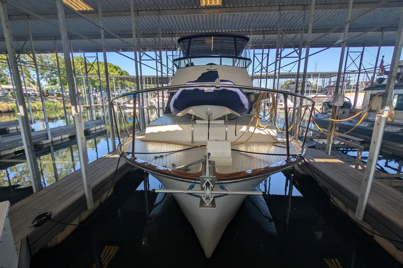 Slide: The Image of 1975 Tollycraft 37 Sedan yacht docked in a covered marina. - 2