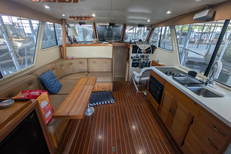 Slide: The Image of Interior of a 1975 Tollycraft 37 Sedan boat with wood flooring and cozy seating. - 21