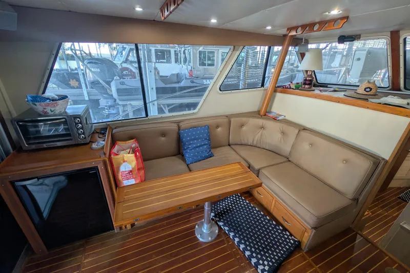 Slide: The Image of Interior of a 1975 Tollycraft 37 Sedan with cozy seating and wooden accents. - 23