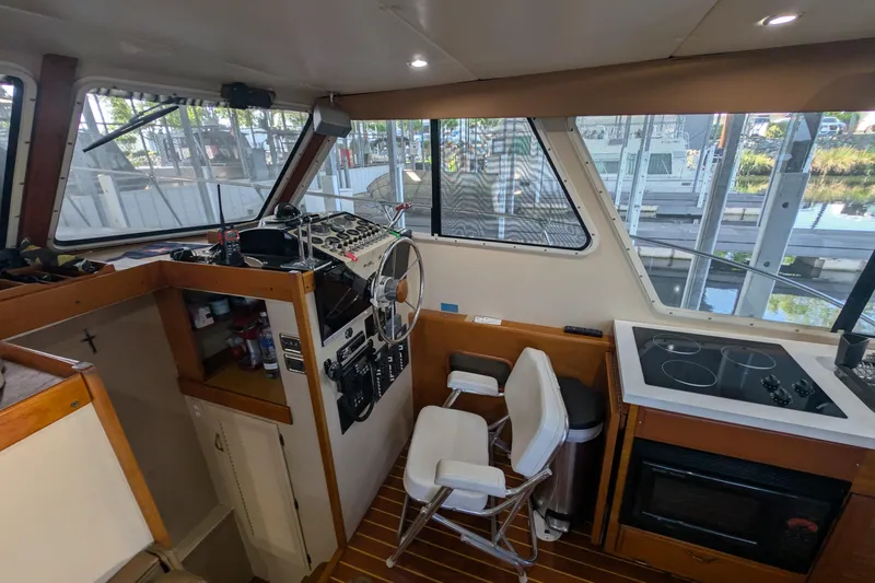 Slide: The Image of Interior of a 1975 Tollycraft 37 Sedan boat with helm and kitchen area. - 25