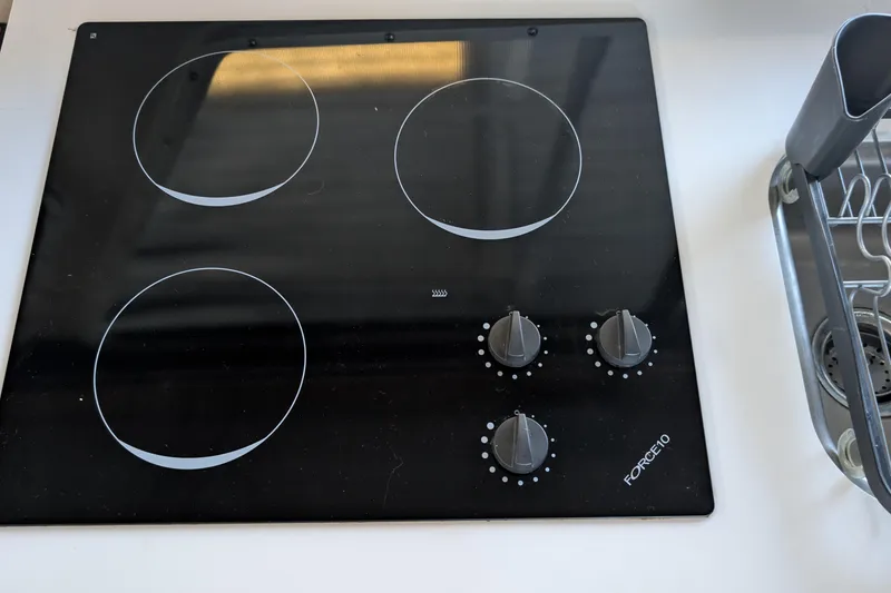 Slide: The Image of Electric stovetop with four burners and control knobs on a Tollycraft 37 Sedan, 1975 model. - 26