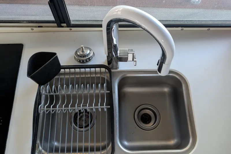 Slide: The Image of Stainless steel sink with modern faucet on 1975 Tollycraft 37 Sedan boat. - 27